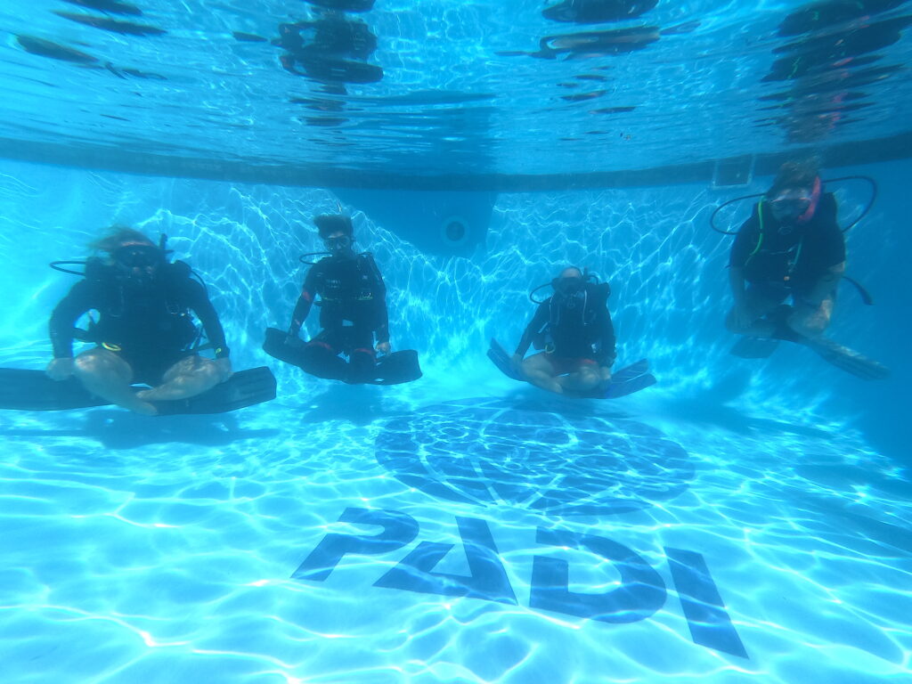 PADI IDC Candidates practicing confined water hovering in the pool