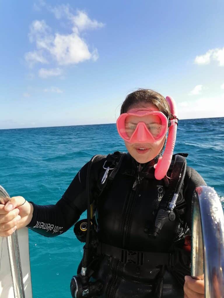 Girls coming out of the water in scuba diving equipment